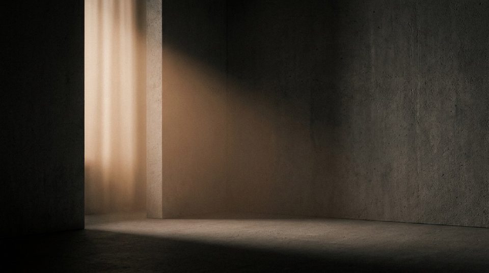 Soft golden light bouncing into a dark concrete corner